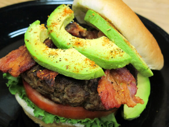Burger with avocado, bacon, lettuce, and tomato