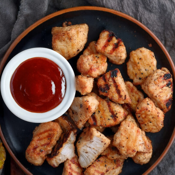 Bone Suckin' Grilled Chicken Nuggets with a cup of sauce