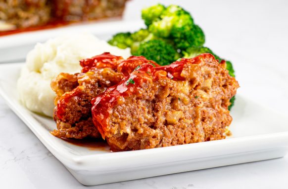 Bone Suckin' Sweet Southern Meatloaf on a plate with broccoli and mashed potatoes