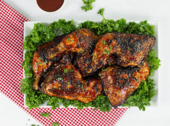 Barbecue chicken leg quarters on a platter