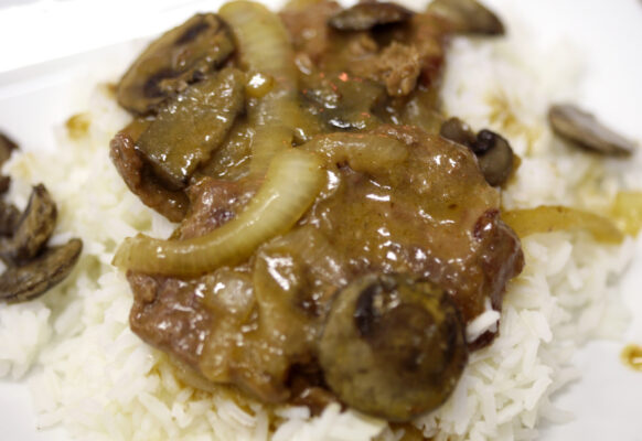 Country Style Steak with mushrooms and onions on rice