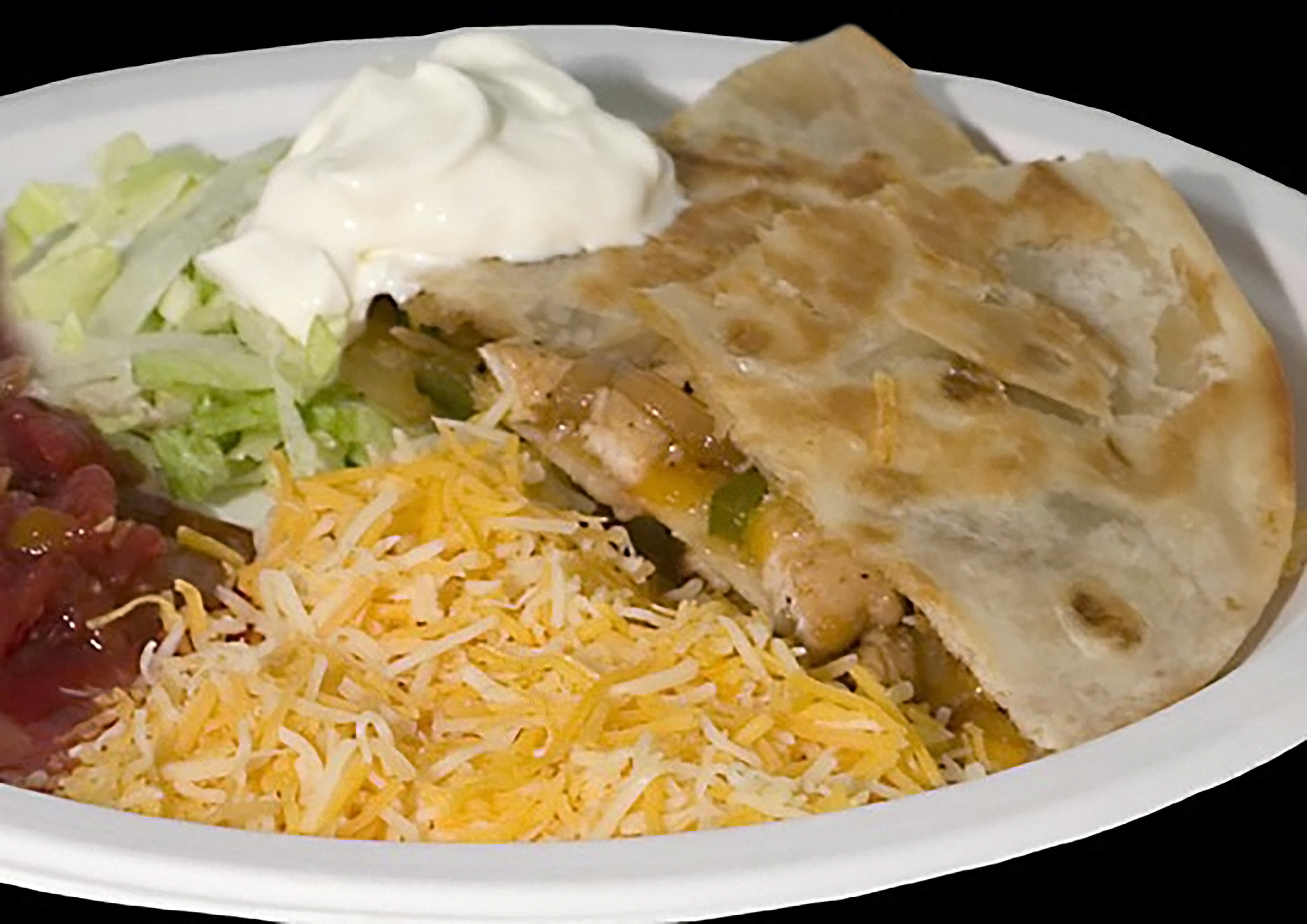 Quesadilla on plate with shredded cheese, sour cream, salsa, and lettuce