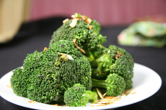 Steamed Broccoli on a plate garnished with almonds
