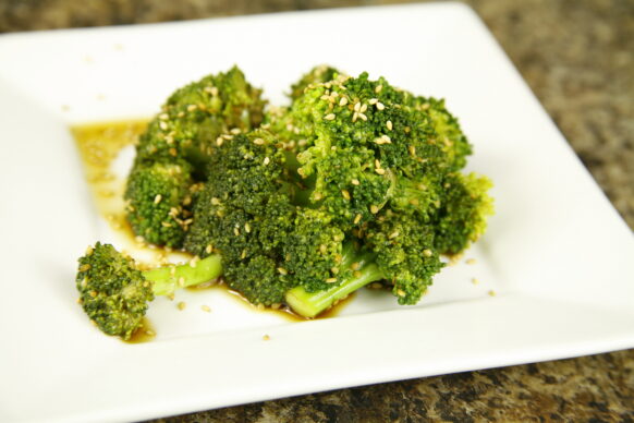 Broccoli with Yaki sauce poured over it and topped with sesame seeds