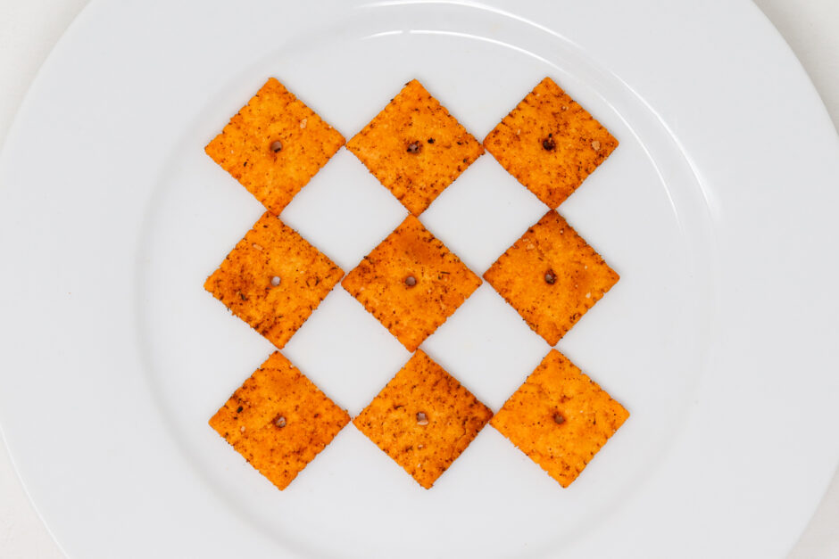 Cajun cheese crackers on white plate.